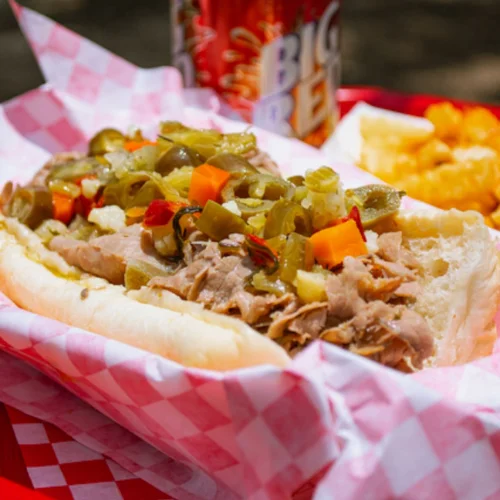 Italian Beef Sandwich - Thinly sliced seasoned beef slow-roasted and dipped in savory au jus, piled high on a French roll. A true Chicago classic.